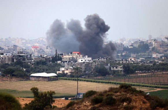 EDITORS NOTE: Graphic content / A picture taken from the southern Israeli city of Sderot on October 17, 2023, shows smoke ascending over the northern Gaza Strip following Israeli military strikes, ami ...