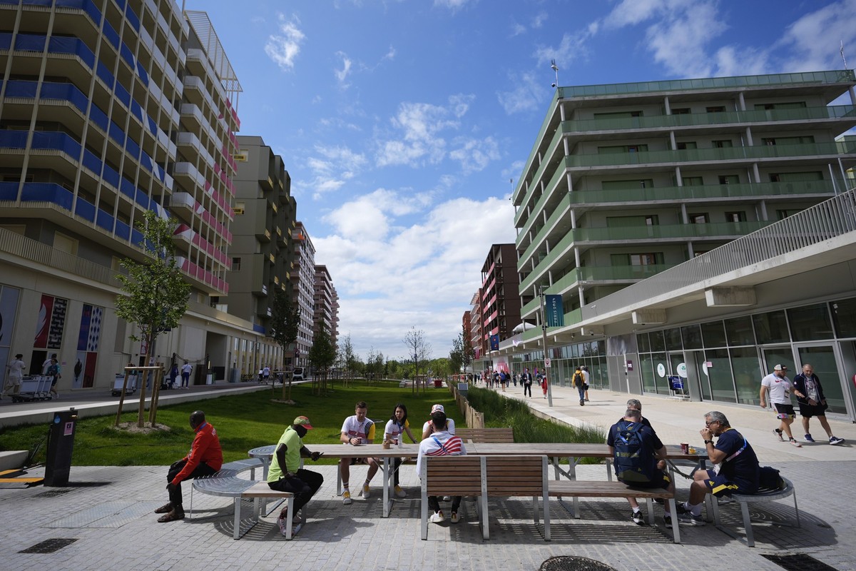 Athletes and team members lounge inside the Olympic Village at the 2024 Summer Olympics, Tuesday, July 23, 2024, in Paris, France. (AP Photo/Rebecca Blackwell)