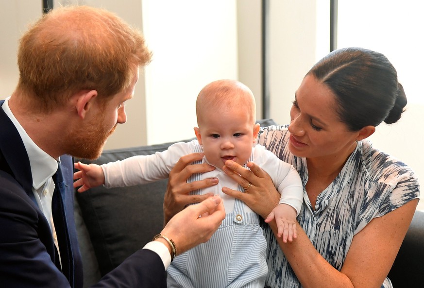 CAPE TOWN, SOUTH AFRICA - SEPTEMBER 25: Prince Harry, Duke of Sussex and Meghan, Duchess of Sussex tend to their baby son Archie Mountbatten-Windsor at a meeting with Archbishop Desmond Tutu at the De ...
