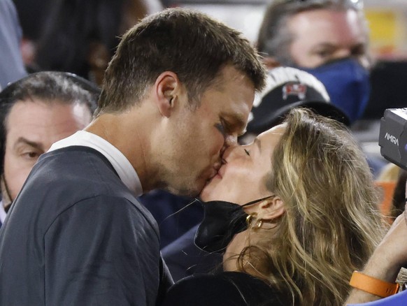 Tampa Bay Buccaneers quarterback Tom Brady kisses his wife Gisele Bundchen as he celebrates the Buccaneers Super Bowl LV victory over the Kansas City Chiefs at Raymond James Stadium in Tampa, Florida  ...