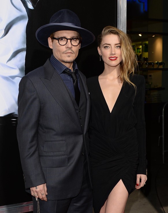HOLLYWOOD, CA - FEBRUARY 12: Actor Johnny Depp and actress Amber Heard arrive at the premiere of &quot;3 Days to Kill&quot; at ArcLight Cinemas on February 12, 2014 in Hollywood, California. (Photo by ...