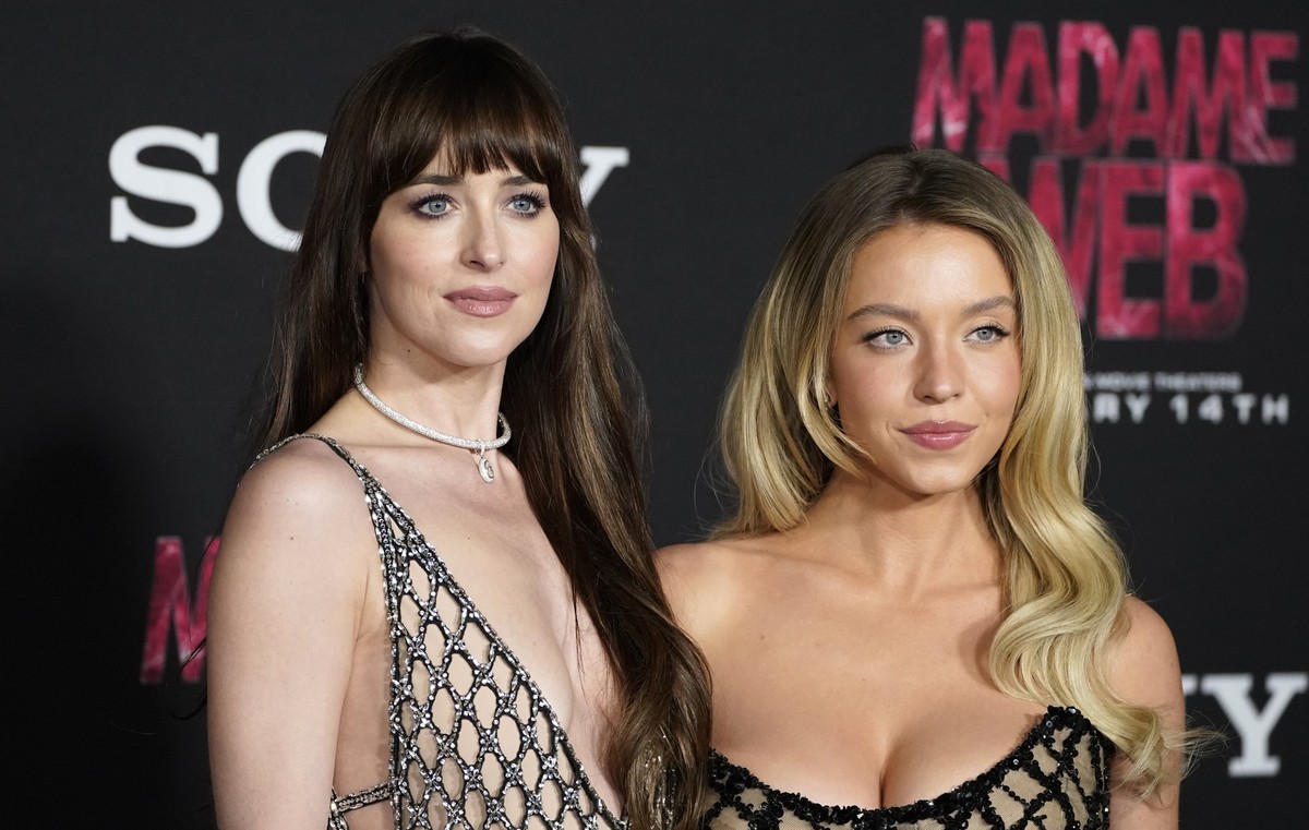 Dakota Johnson, left, and Sydney Sweeney arrive at the premiere of &quot;Madame Web,&quot; Monday, Feb. 12, 2024, at the Regency Village Theatre in Los Angeles. (Photo by Jordan Strauss/Invision/AP)