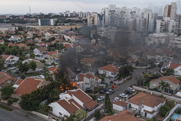 Smoke rises after a rocket fired from the Gaza Strip hit a house in Ashkelon, southern Israel, Saturday, Oct. 7, 2023. The rockets were fired as Hamas announced a new operation against Israel. (AP Pho ...
