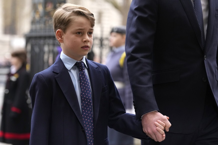 FILE - Britain&#039;s Prince George holds the hand of his father Prince William as they arrive to attend a Service of Thanksgiving for the life of Prince Philip, Duke of Edinburgh at Westminster Abbey ...