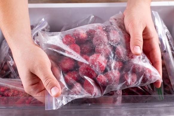Frozen strawberries. Frozen berries and fruits in a plastic bag in freezer