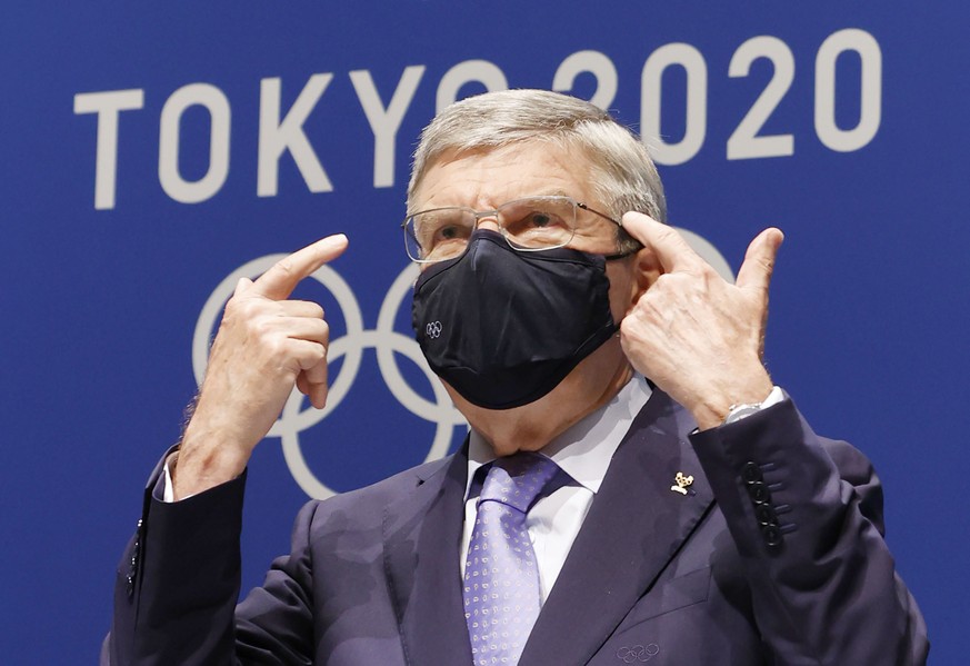 IOC President Thomas Bach gestures during a press conference at the Main Press Center, ahead of the Tokyo 2020 Olympic and Paralympic Games in Tokyo, Saturday, July 17, 2021. The first resident of the ...