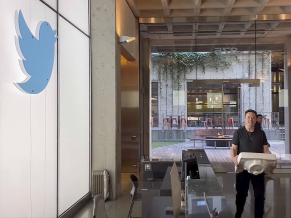 This image from the Twitter page of Elon Musk shows Musk entering Twitter headquarters carrying a sink through the lobby area on Wednesday, Oct. 26, 2022 in San Francisco. Musk posted a video Wednesda ...
