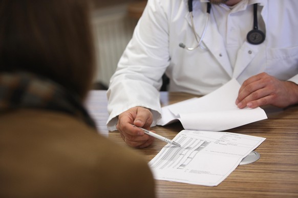 BERLIN, GERMANY - SEPTEMBER 05: A doctor speaks with a patient about her high blood pressure, or hypertension, on September 5, 2012 in Berlin, Germany. Doctors in the country are demanding higher paym ...