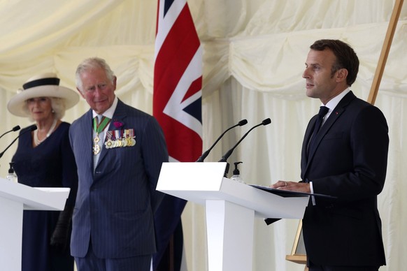 FILE - Britain&#039;s Prince Charles and Camilla, Duchess of Cornwall look on as French President Emmanuel Macron, right, makes a speech following laying a wreath at a ceremony at Carlton Gardens in L ...