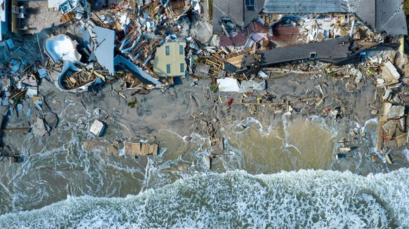 An aerial view of destroyed beachfront homes in the aftermath of Hurricane Nicole at Daytona Beach, Florida, on November 11, 2022. - The rare late storm sparked mandatory evacuation orders just weeks  ...