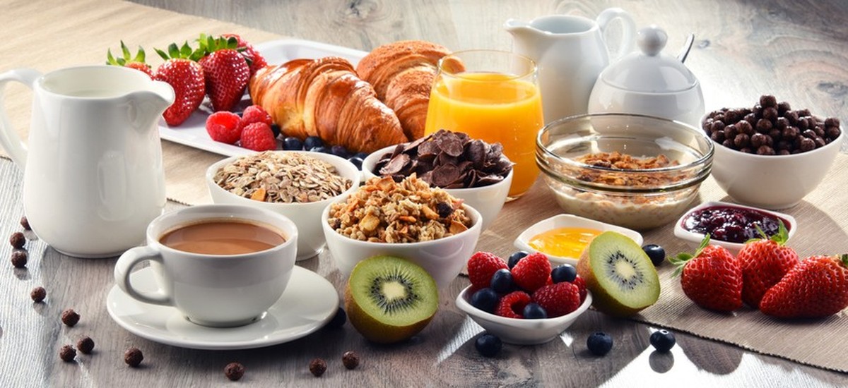 Breakfast served with coffee, orange juice, croissants, cereals and fruits. Balanced diet.