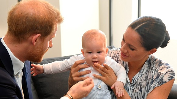 CAPE TOWN, SOUTH AFRICA - SEPTEMBER 25: Prince Harry, Duke of Sussex and Meghan, Duchess of Sussex tend to their baby son Archie Mountbatten-Windsor at a meeting with Archbishop Desmond Tutu at the De ...