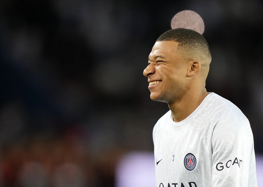 PSG&#039;s Kylian Mbappe smiles during the warm up before the Champions League Group H soccer match between Paris Saint Germain and Benfica, at the Parc des Princes stadium, in Paris, France, Tuesday, ...