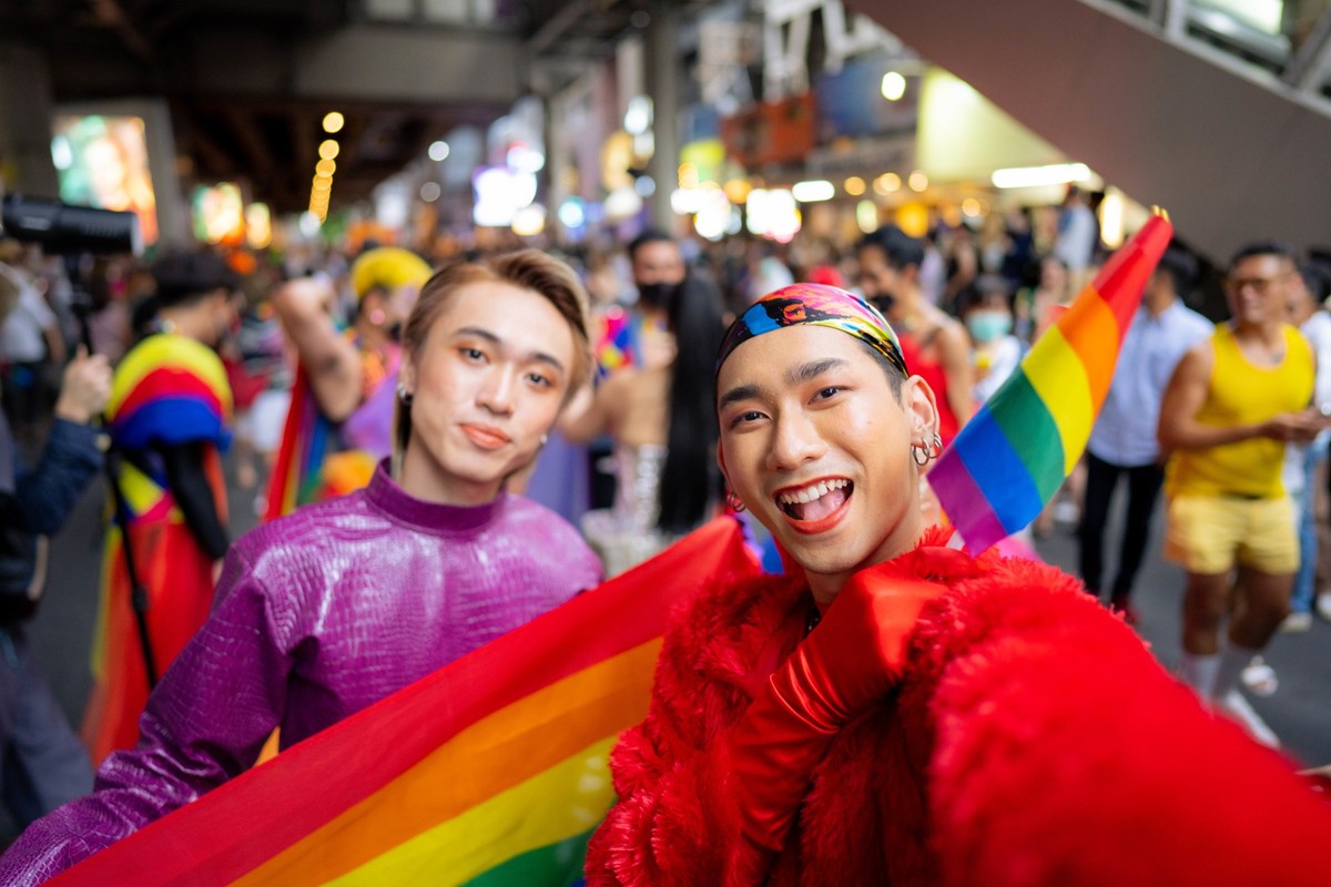 Gay Asians enjoying the Pride parade on the streets of Thailand.
