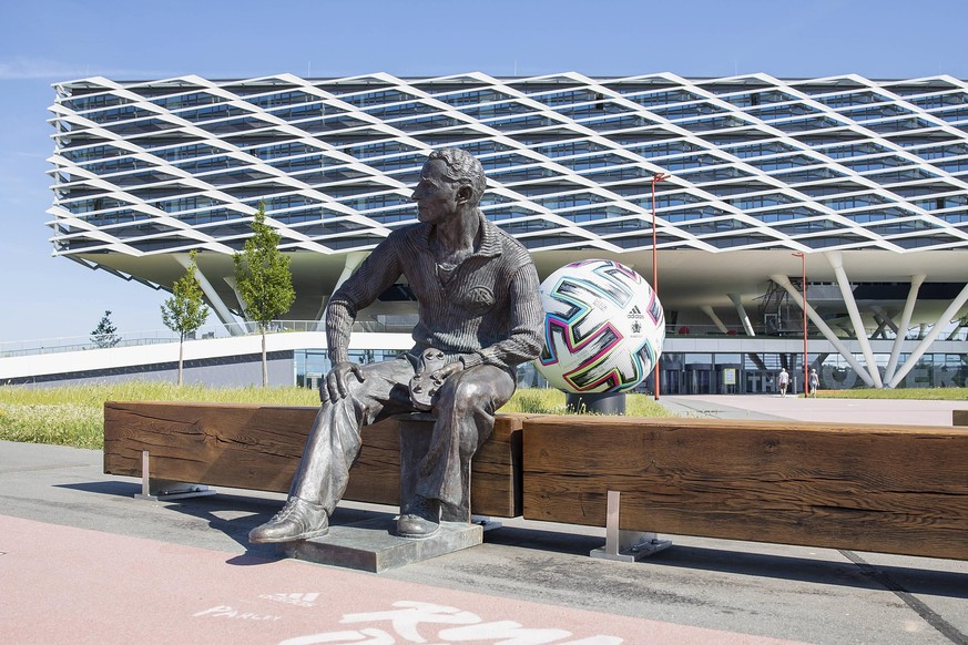 Die Statue von Adidas-Gründer Adi Dassler vor dem Adidas-Verwaltungsgebäude. Dahinter trainiert die DFB-Elf. 