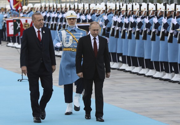 Turkey&#039;s President Recep Tayyip Erdogan left, walks with Russia&#039;s President Vladimir Putin, centre, during a welcome ceremony, in Ankara, Turkey, Tuesday, April 3, 2018. Putin, on his first  ...