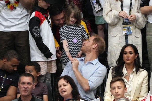 Britain&#039;s Prince Harry and Meghan, The Duke and Duchess of Sussex, watch a sitting volleyball match at the Invictus Games in Duesseldorf, Germany, Friday, Sept. 15, 2023. Harry gets a present fro ...