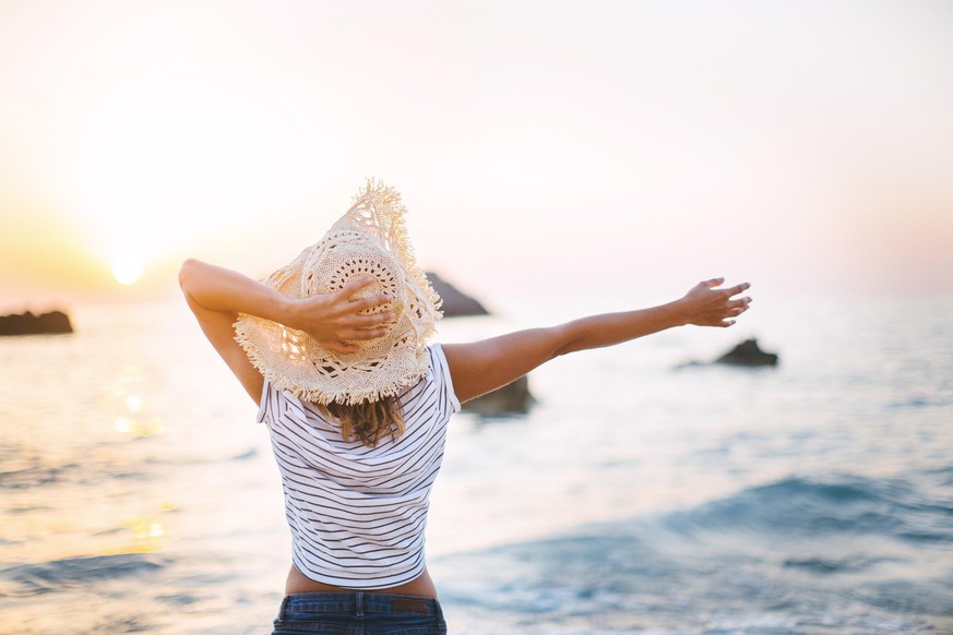 Beautiful woman on hot summer day enjoying on beach