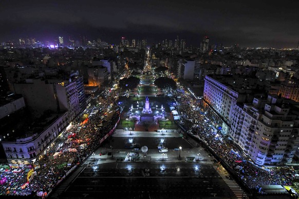 In this photo released by Argentina&#039;s Senate press office, protesters demonstrate in support of loosening the abortion law, left, and against abortion, right, in this photo taken from Congress wh ...