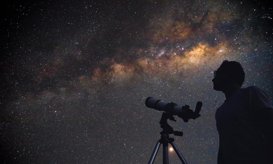 Astronomer with a telescope watching at the stars and Moon. My astronomy work.