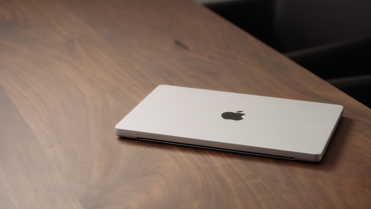 Saint-Petersburg, Russia - Circa December, 2022: CLoseup of the Macbook on walnut wood table with , illustrative editorial Model Released Property Released xkwx macbook pro open 14 inch new charger ma ...