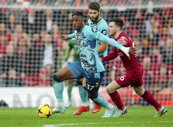 Liverpool&#039;s Andrew Robertson, right, challenges for the ball with Southampton&#039;s Armel Bella-Kotchap during the English Premier League soccer match between Liverpool and Southampton at Anfiel ...