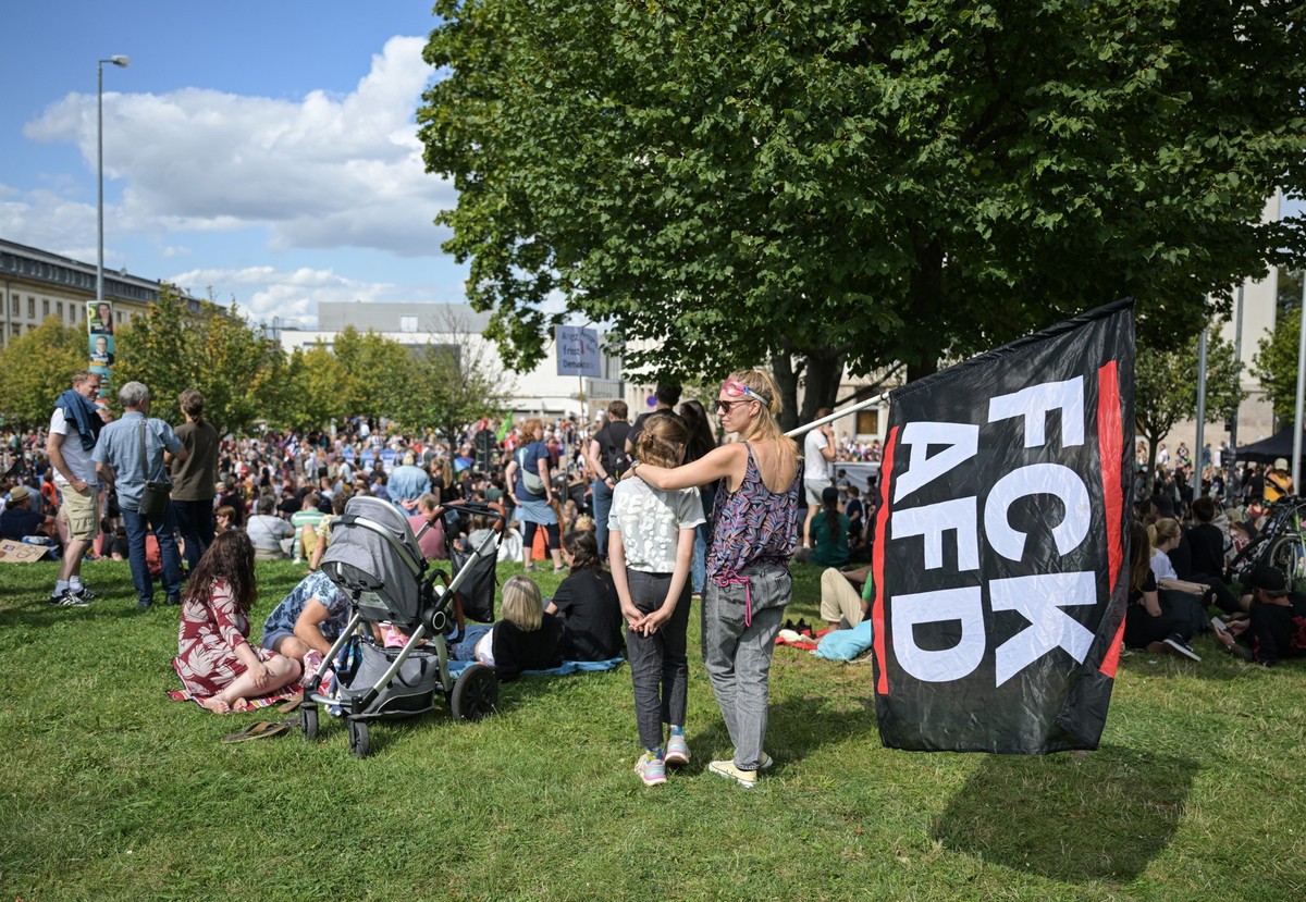 25.08.2024, Thüringen, Erfurt: Eine Demonstrantin trägt eine Flagge mit der Aufschrift «FCK AFD». Die Initiative Weltoffenes Thüringen hat zu einer Demonstration unter dem Motto «Thüringen auf der Kip ...