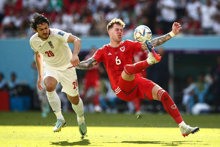 Mandatory Credit: Photo by Michael Zemanek/Shutterstock 13634746z Joe Rod-on of Wales clears under pressure from Sardar Azmoun of Iran Wales v Iran, FIFA World Cup, WM, Weltmeisterschaft, Fussball 202 ...