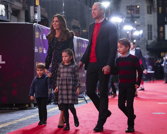 LONDON, ENGLAND - DECEMBER 11: Prince William, Duke of Cambridge and Catherine, Duchess of Cambridge with their children, Prince Louis, Princess Charlotte and Prince George, attend a special pantomime ...