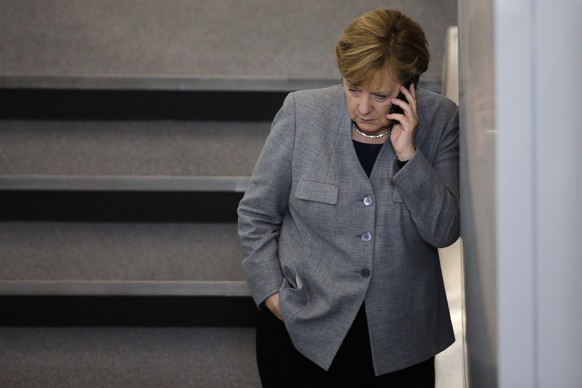 FILE -- In this Oct. 24, 2017 file photo German Chancellor Angela Merkel phones during a break of a meeting of the German parliament in Berlin, Germany. Russian pranksters posed as Ukraine’s ex-Presid ...