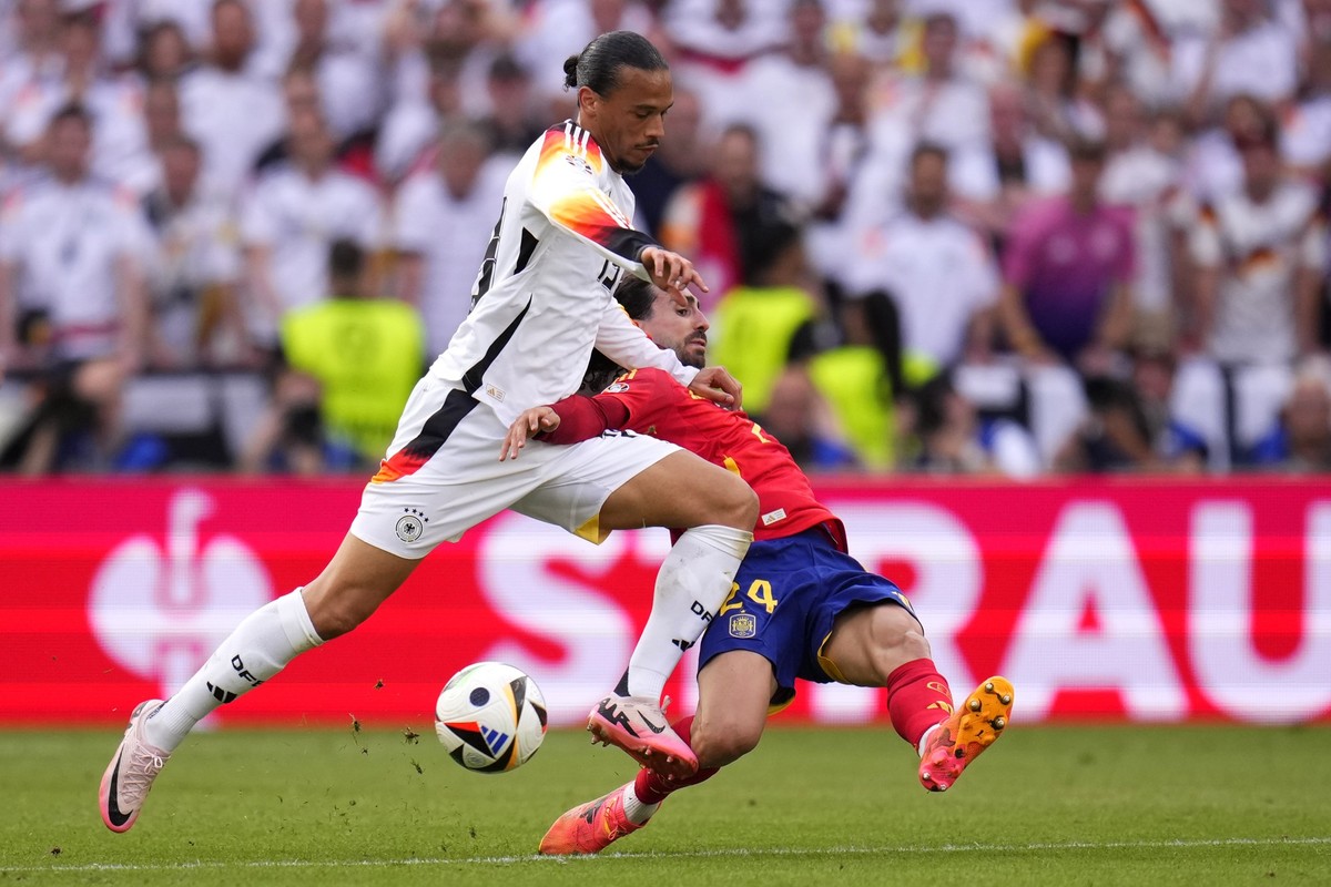 Spain&#039;s Marc Cucurella, right, challenges Germany&#039;s Leroy Sane during a quarter final match between Germany and Spain at the Euro 2024 soccer tournament in Stuttgart, Germany, Friday, July 5 ...