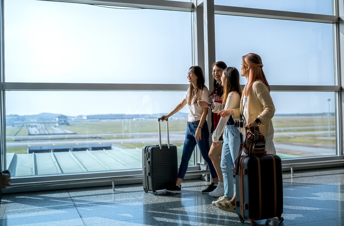 All females trip : Taking selfie at airport while waiting for departure
