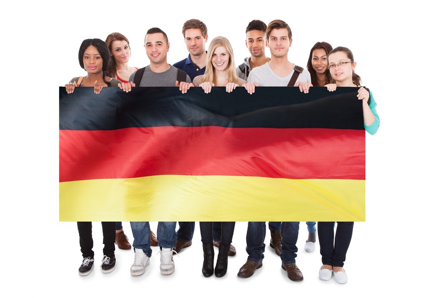 Group Of Young People Holding German Flag Against White Background