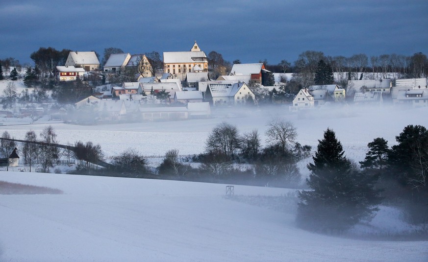 17.01.2023, Baden-Württemberg, Langenenslingen: Blick auf die Kirche St. Jakobus in Dürrenwaldstetten auf der Schwäbischen Alb. In der Nacht hat es geschneit. Foto: Thomas Warnack/dpa +++ dpa-Bildfunk ...