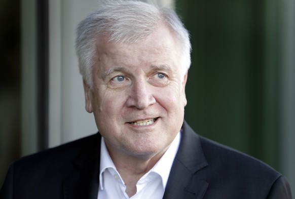 German Interior Minister and chairman of the German Christian Social Union (CDU), Horst Seehofer, speaks as he arrives for a meeting with German Chancellor and chairwoman of the German Christian Democ ...
