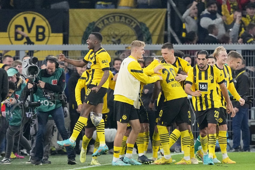 Dortmund&#039;s Youssoufa Moukoko, left, celebrates after teammate Anthony Modeste, center, score their side&#039;s second goal during the German Bundesliga soccer match between Borussia Dortmund and  ...