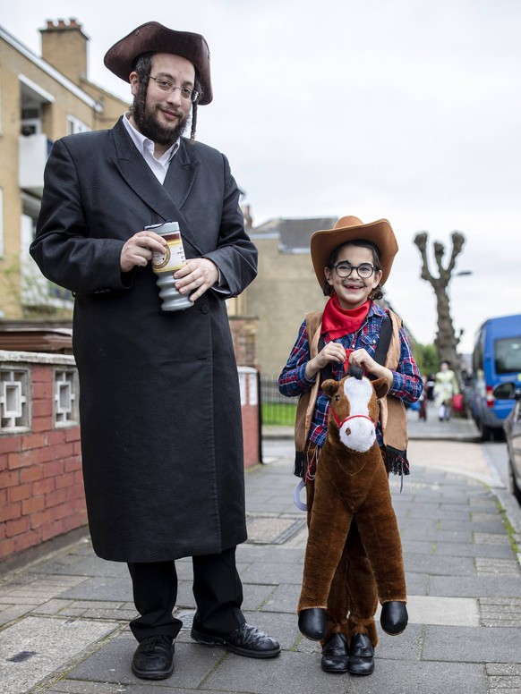 March 21, 2019 - London, UK, United Kingdom - Orthodox couple seen wearing fancy dresses during the festival of Purim on the streets of Stamford Hill in north London..Purim is one of the most entertai ...