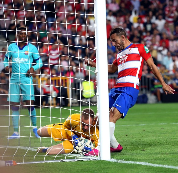 Granada s forward Roberto Soldado R in action against Barcelona s goalkeeper Marc-Andre Ter Stegen C during the Spanish LaLiga match between Granada CF and FC Barcelona, Barca at Nuevo Los Carmenes st ...