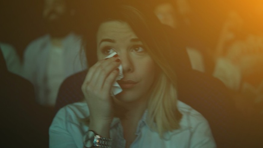 Young couple at the cinema watching movie