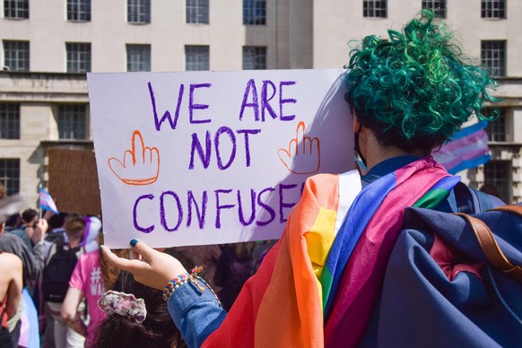 August 6, 2021, London, United Kingdom: A protester holds a We Are Not Confused placard during the trans rights demonstration..Protesters gathered outside Downing Street demanding an end to discrimina ...