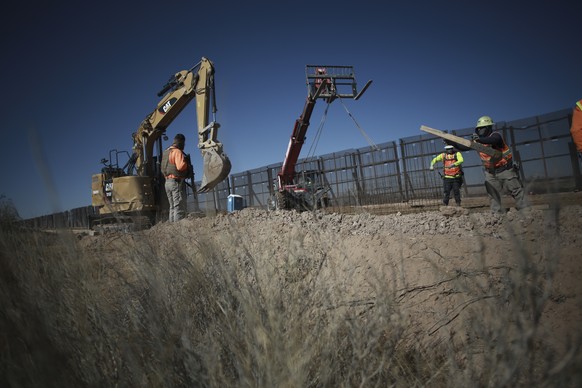 Workers prepare the foundation for a steel section of border wall that will be built on the Mexican side of older metal fencing dividing Ciudad Juarez, Mexico from Sunland Park, New Mexico, in Ciudad  ...