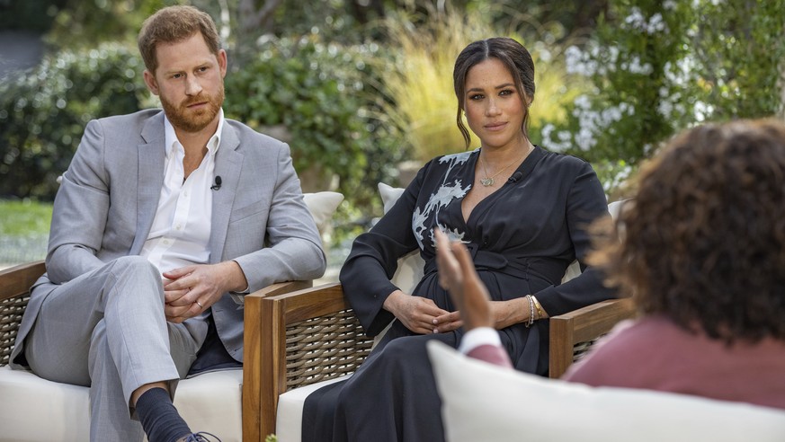 FILE - This image provided by Harpo Productions shows Prince Harry, from left, and Meghan, Duchess of Sussex, in conversation with Oprah Winfrey. Almost as soon as the interview aired, many were quick ...