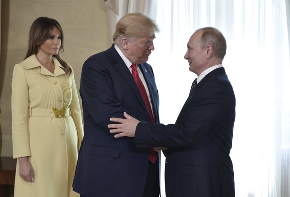 U .S. First Lady Melania Trump, left, looks on as U.S. President Donald Trump and Russian President Vladimir Putin welcome each other at the Presidential Palace in Helsinki, Finland, Monday, July 16,  ...