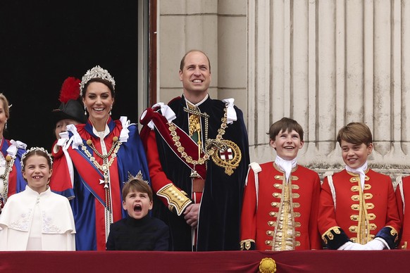 Britain&#039;s Prince Louis reacts next to his sister Princess Charlotte, left, his mother Kate, Princess of Wales, his father Prince William, center, and his brother Prince George, second from right, ...