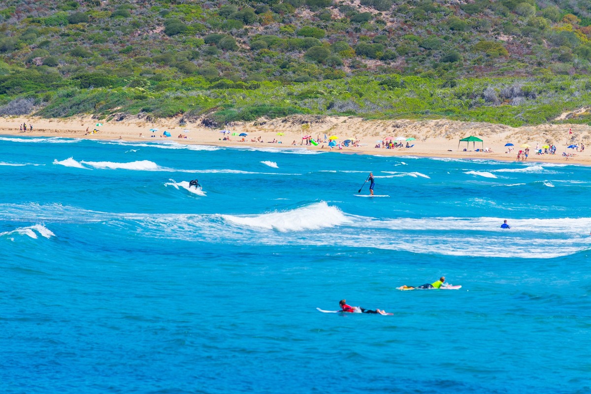 Surfers in Porto Ferro beach on a summer day. Sardinia, Italy xkwx surfing, surf, surfer, paddling, sardinia, water, man, wave, mediterranean, italy, fun, travel, beach, scenic, watersports, epic, blu ...