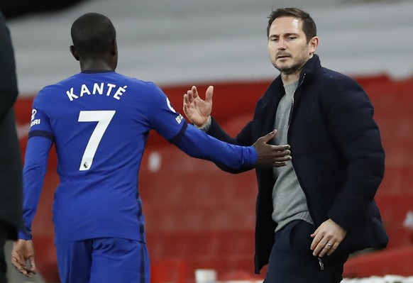 Chelsea's N'Golo Kante, left goes to shake hands with Chelsea's head coach Frank Lampard as he is substituted during their English Premier League soccer match between Arsenal and Chelsea at the Emirat ...