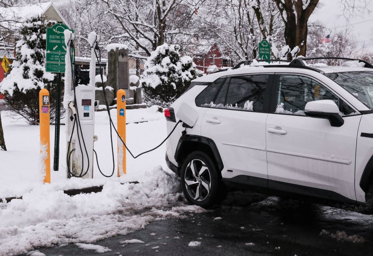 A electric car is charging at a station covered by snow in Sparkill, New York, on February 13, 2024. Millions of people in the northeastern US were engulfed by snow on February 13 as a powerful winter ...