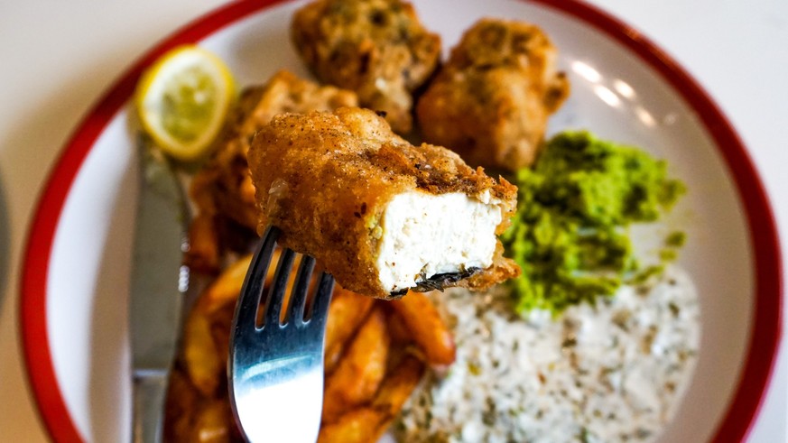 Vegan fish and chips with vegan source, tofu and chips with lemon. heath eating.