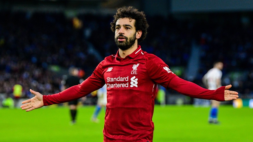 Mohamed Salah of Liverpool (11) Celebrates scoring his sides 1st goal and the match winner and salutes to fans during the Premier League match between Brighton and Hove Albion and Liverpool at the Ame ...