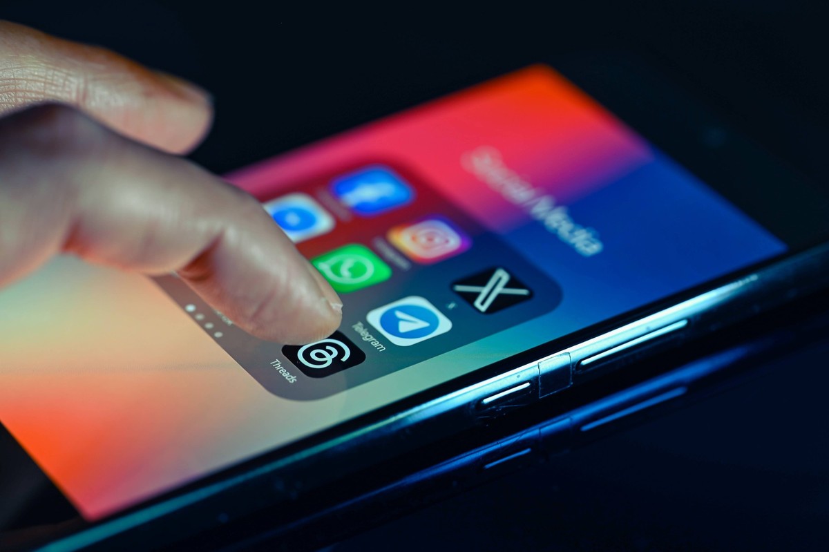 Social Media App Photo Illustration Close - up finger pointing to Threads mobile app displayed on a smartphone screen alongside that of Facebook,Whatsapp,Telegram,TikTok,X, on August 15, 2023, in Brus ...